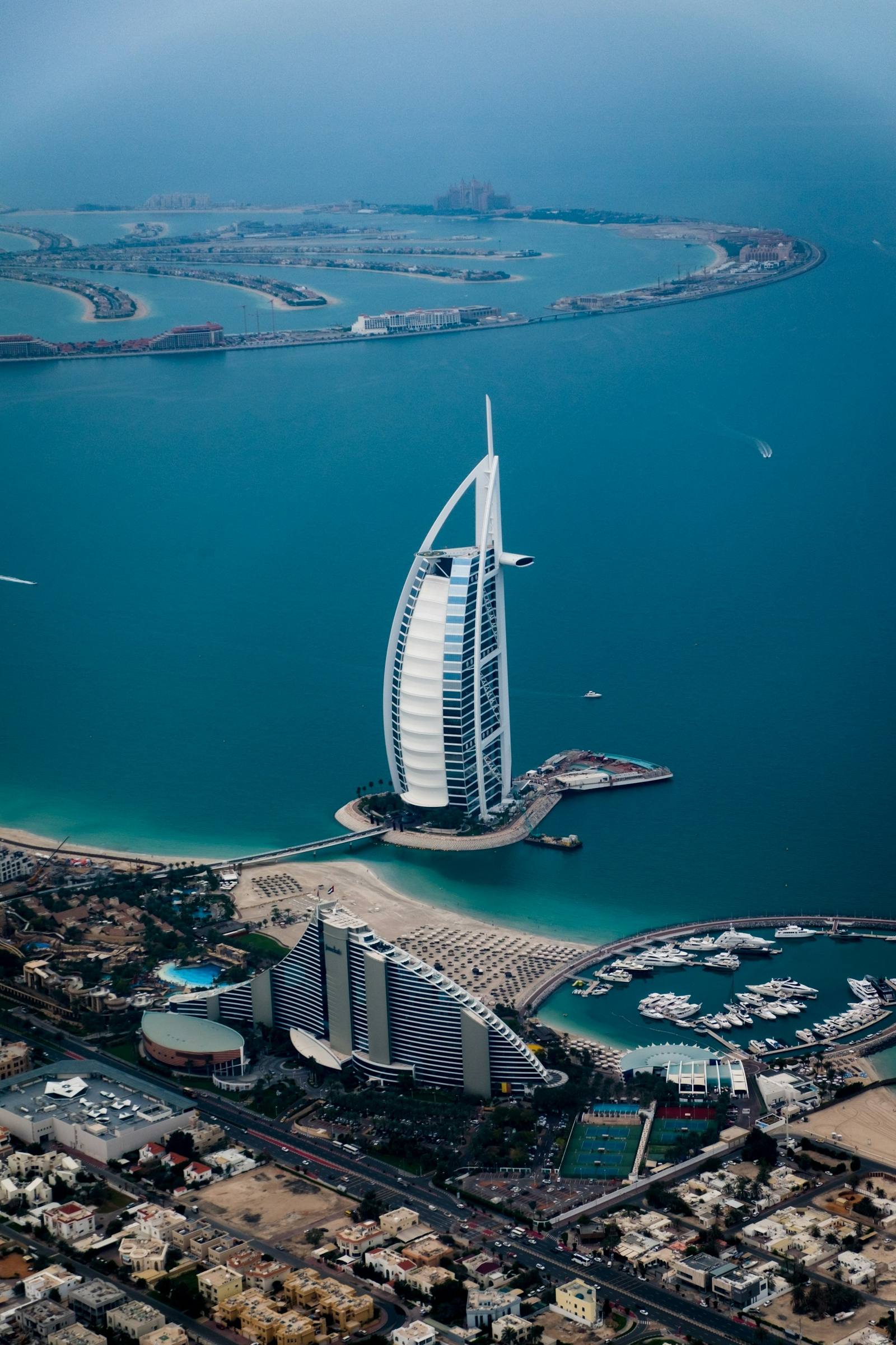 Aerial view of Dubai's coastline and waterfront at dusk
